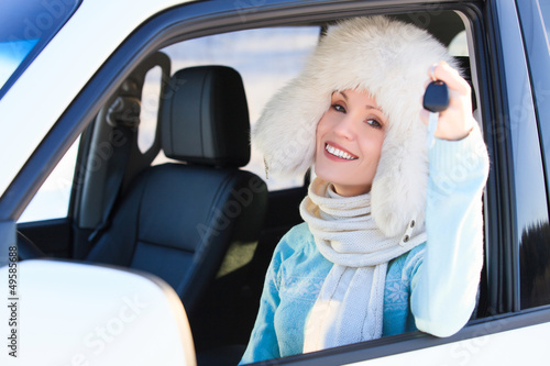 Photo: Happy woman in white fur hat in a car Happy woman in white fur hat in a car