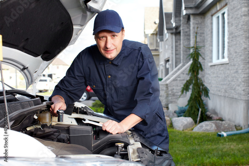 Photo: Professional auto mechanic. Professional auto mechanic.