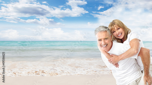 Photo: Happy senior couple on the beach. Happy senior couple on the beach.