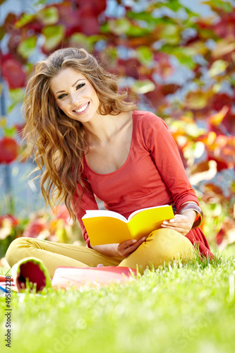 Photo: beautiful girl with book in the spring park beautiful girl with book in the spring park