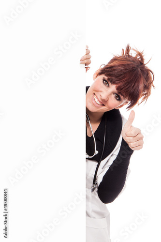 Photo: Smiling brunette female doctor with message board Smiling brunette female doctor with message board