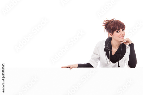 Photo: Smiling brunette female doctor with message board Smiling brunette female doctor with message board