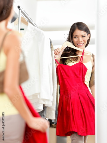 Photo: Shopper woman trying clothing dress shopping Shopper woman trying clothing dress shopping