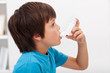 Boy using inhaler