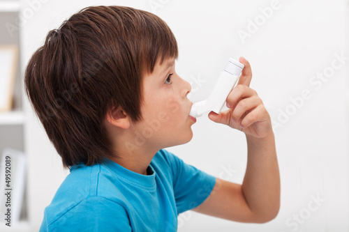 Photo: Boy using inhaler Boy using inhaler