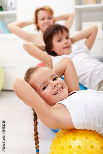 Photo: Kids exercising with their mother Kids exercising with their mother
