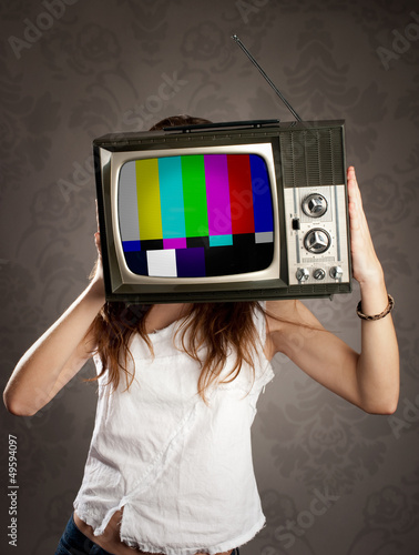 Photo: woman holding old television on her head woman holding old television on her head