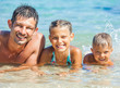 Photo: Father with his kids have fun and swim sea Father with his kids have fun and swim sea