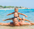 Photo: Father with his kids have fun and swim sea Father with his kids have fun and swim sea