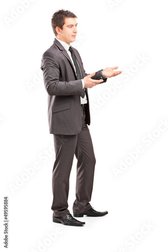 Photo: Full length portrait of a professional male shot during a conver Full length portrait of a professional male shot during a conver