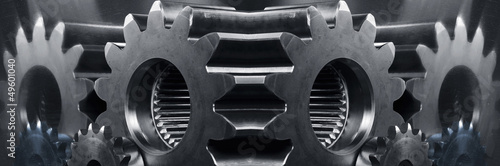 Photo: gears and cogwheels panoramic mirror image in blue toning gears and cogwheels panoramic mirror image in blue toning