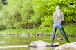 woman fishing in Sazava river, Czech Republic