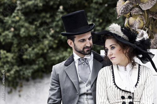 Photo: Old Fashioned dressed couple in love in the park Old Fashioned dressed couple in love in the park