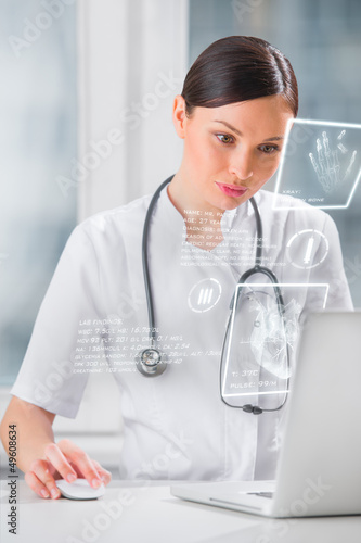 Photo: Doctor with hightech computer screen viewing patient data Doctor with hightech computer screen viewing patient data
