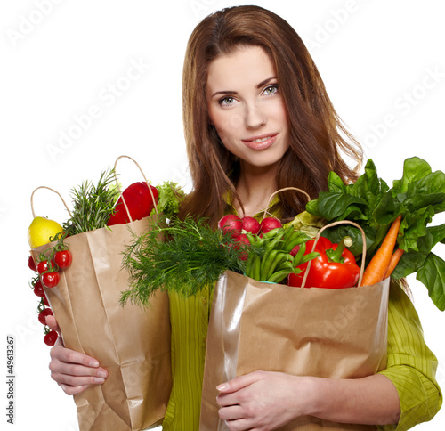 Photo: beautiful young woman with vegetables and fruits in shopping bag beautiful young woman with vegetables and fruits in shopping bag