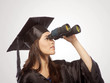 Graduate looking through Binocular
