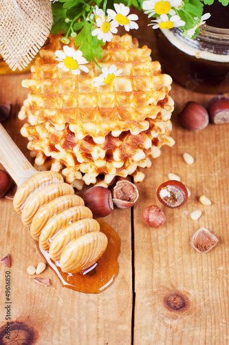 Photo: Waffles with honey and nuts on a wooden surface Waffles with honey and nuts on a wooden surface