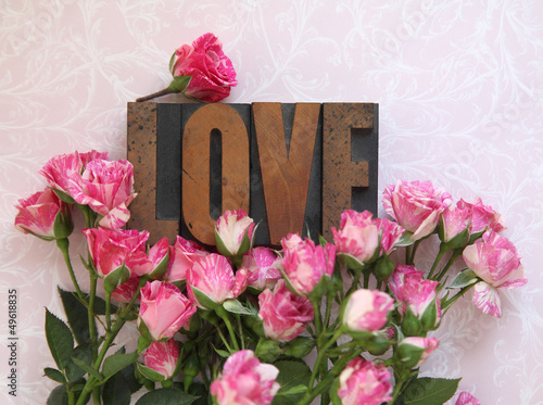 Photo: love word in wood type with roses love word in wood type with roses