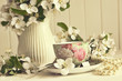 Tea cup with apple blossoms on table