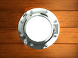 Silver porthole in wooden boat