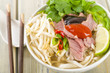 Pho Bo - Vietnamese rice noodle soup with beef, herbs and chili