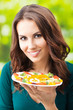 Young woman with salad, outdoors