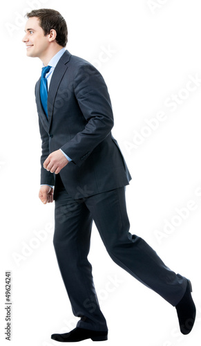 Photo: Full body of walking businessman, isolated Full body of walking businessman, isolated