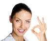 Cheerful businesswoman with okay sign, over white