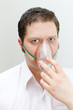 Portrait of young man with inhalator mask on the face