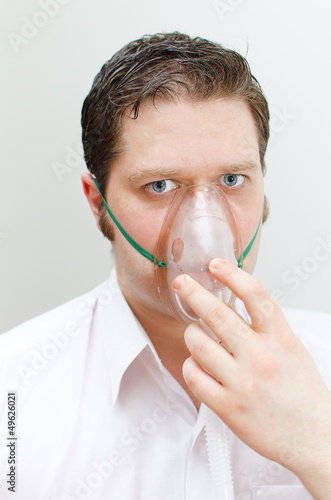 Photo: Portrait of young man with inhalator mask on the face Portrait of young man with inhalator mask on the face
