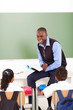 male african primary school teacher teaching in classroom