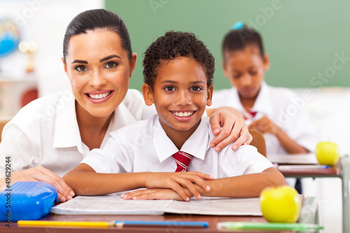 Photo: attractive elementary school teacher and students in classroom attractive elementary school teacher and students in classroom