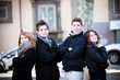four happy teenagers posing for a photo