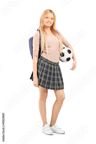 Photo: Full length portrait of a young female student with bag holding Full length portrait of a young female student with bag holding