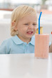 Little blond boy in a cafe
