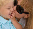 Mom kissing her little son