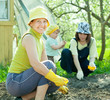   women with child works at vegetables garden