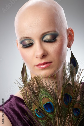 Photo: Bald woman with peacock plumes Bald woman with peacock plumes