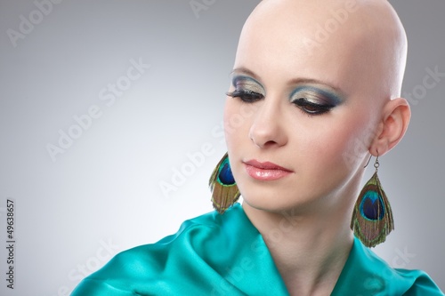 Photo: Portrait of hairless woman in turquoise silk dress Portrait of hairless woman in turquoise silk dress
