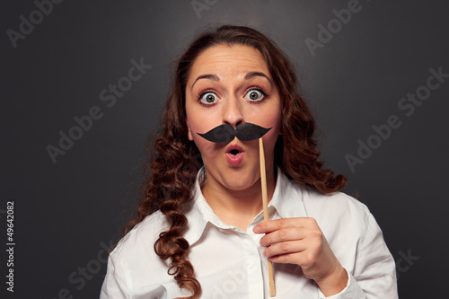 Photo: amazed woman with fake mustache amazed woman with fake mustache