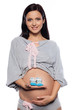Pregnant woman holding baby shoes