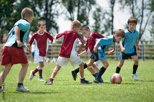 Photo: kids playing football outside kids playing football outside