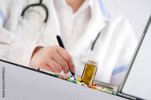 Photo: Doctor writing a prescription Doctor writing a prescription