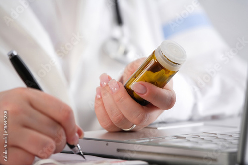 Photo: Doctor writing a prescription Doctor writing a prescription