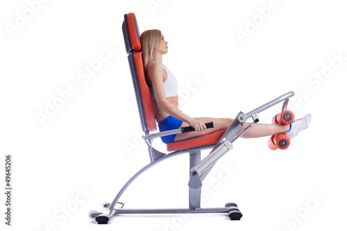 Photo: Beauty woman sitting on orange hydraulic exerciser Beauty woman sitting on orange hydraulic exerciser