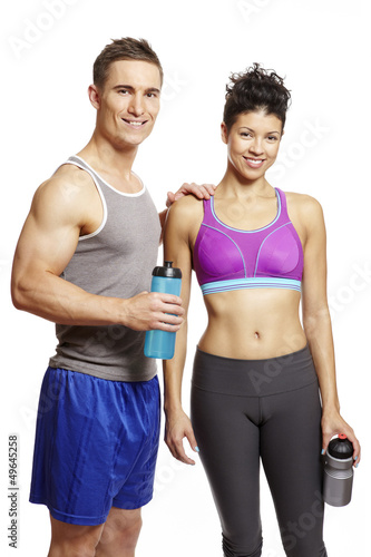 Photo: Young man and woman relaxing in sports outfits Young man and woman relaxing in sports outfits