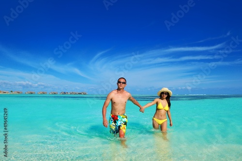 Photo: happy young couple enjoying summer on beach happy young couple enjoying summer on beach