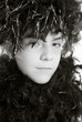 Photo: Young girl in feather boa Young girl in feather boa