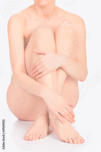 Photo: Naked woman on white floor Naked woman on white floor