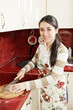 Photo: Smiling housewife cutting cabbage Smiling housewife cutting cabbage